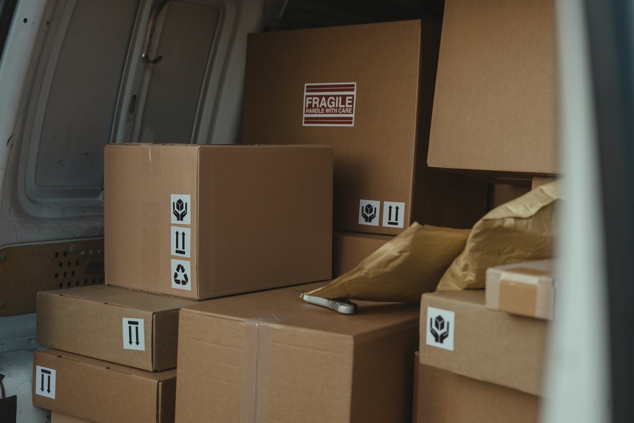 creative-01 Neatly organized cardboard boxes inside a delivery van, ready for shipment.